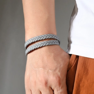 Close-up of grey double-wrap braided leather bracelet with magnetic clasp on wrist
