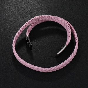 Macro detail of pink braided leather bracelet with silver magnetic metal clasp closure