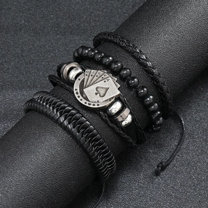 Detail of four-piece men's leather bracelets with Ace of Spades poker engraving