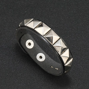 Punk black leather bracelet with silver square pyramid studs and metal buckle closure