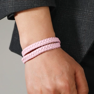 Close-up of pink double-layered braided leather bracelet with magnetic clasp on wrist