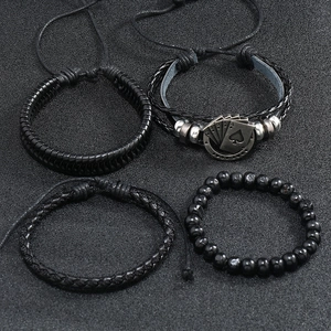Detail view of four-piece men's leather bracelet set with spade poker charm and beads
