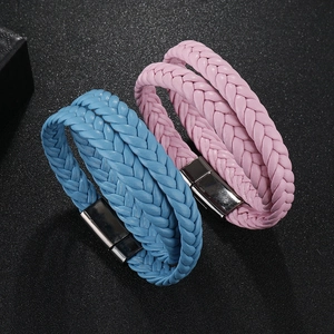 Detailed view of pink and blue woven leather bracelets with metallic magnetic clasps