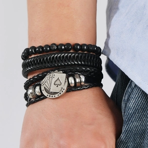Close-up of men's layered leather bracelet featuring poker charms and wooden beads