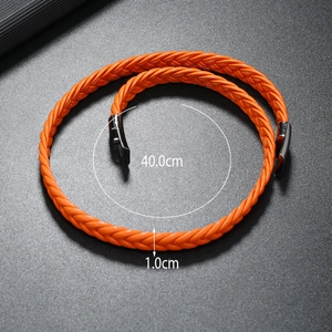 Detail of 40cm orange braided leather bracelet with black metal magnetic clasp