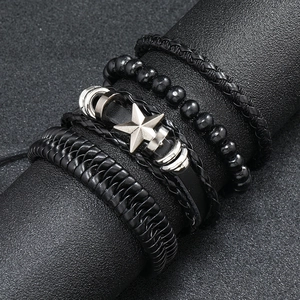 Detail of multi-layer black leather bracelet set with beads and metal star charm