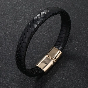 Close-up of black braided leather bracelet featuring a polished gold magnetic buckle