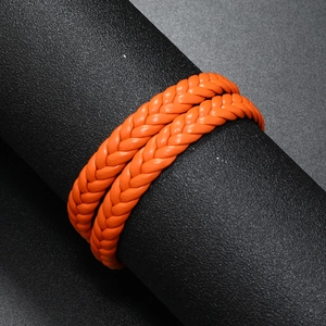 Close-up of vibrant orange double-wrap braided leather bracelet with magnetic clasp