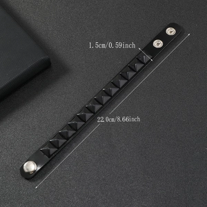 Detail view of punk black studded leather bracelet with matte pyramid rivets and dimensions