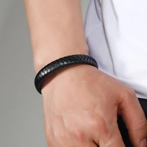 Minimalist black braided leather bracelet for men with secure magnetic clasp on wrist