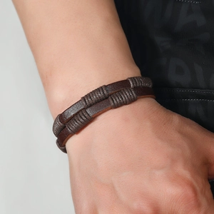 Men's double-layered brown braided leather bracelet with cord wrap on male wrist