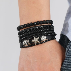 Detailed view of multilayer handcrafted leather bracelets with a vintage silver star charm
