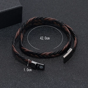 Detail of multi-layer braided leather bracelet featuring a silver magnetic clasp closure