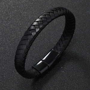 Macro detail of multi-strand braided black leather bracelet with sleek matte metal clasp