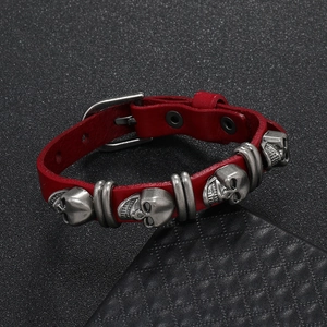 Retro red leather punk bracelet with silver skull charms and metal rivet details