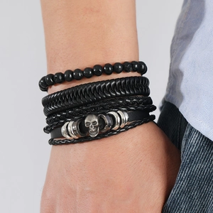 Close-up of multilayer men's leather bracelet featuring an antique silver skull detail