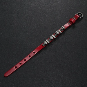 Detail of red punk leather bracelet with silver skull studs and adjustable metal buckle