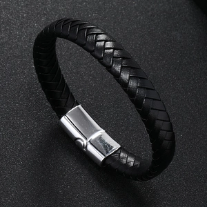 Close-up of braided black leather bracelet featuring a silver brushed magnetic clasp