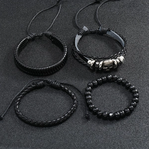 Detailed view of 4pcs set men's black braided leather and beaded bracelets with skull charm
