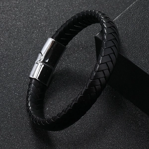 Macro shot of men's braided leather bracelet with a polished silver magnetic buckle