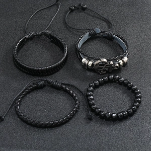 Detail view of 4-piece men's vintage black leather woven bracelets with anchor charm and beads