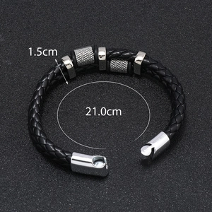 Detail view of black woven leather bracelet showing 1.5cm width and 21.0cm inner circumference