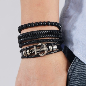 Detail of men's multi-layer woven leather bracelets with silver anchor charm