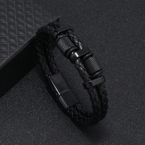 Detail of multi-layer black braided leather bracelet with matte metal magnetic clasp