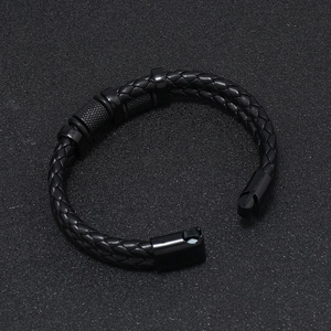 Detailed close-up of men's multi-layer black braided leather bracelet with magnetic buckle