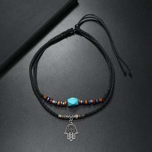 Bohemian Hamsa Hand pendant necklace with turquoise beads and braided cord detail