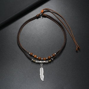 Vintage layered beaded necklace with silver feather pendant and wooden beads on black cord