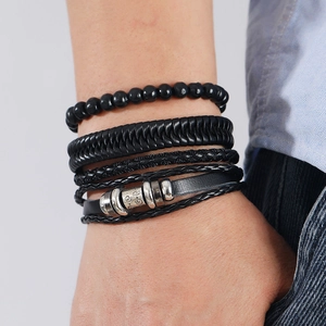 Detailed close-up of a men's vintage black multi-layer braided leather and bead bracelet set