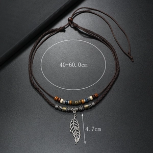 Detailed view of adjustable vintage feather pendant necklace with colorful wooden beads