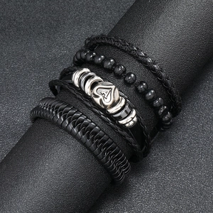 Detail of four-piece men's leather bracelets with Ace of Spades metal charm and black beads