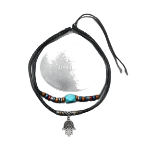 Ethnic multilayer necklace with turquoise beads and Hamsa Hand pendant on white background