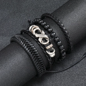 Detailed macro view of four-piece vintage black braided leather bracelets with silver accents