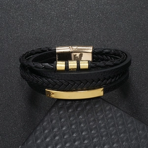 Detail of multi-layer men's braided leather bracelet with golden magnetic clasp