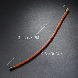 Detailed view of 21cm brown braided leather bracelet with vintage gold magnetic clasp