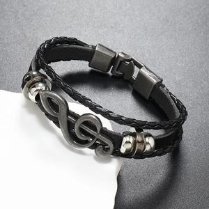 Detail of multi-layer black leather bracelet featuring a silver G-clef music note symbol