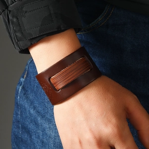 Macro view of vintage brown leather bracelet with wood-grain inlay and rustic punk details