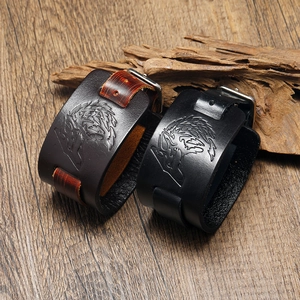 Detailed view of embossed wolf head totem on premium brown and black leather bracelets