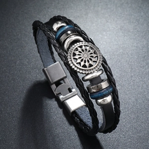 Detail of retro multilayer black leather bracelet with silver sunflower metal charm