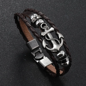 Close-up of vintage silver anchor charm on multilayer dark brown braided leather bracelet