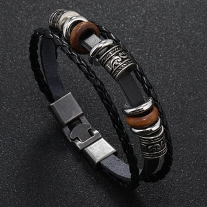Detail of punk leather bracelet showing woven cords and stainless steel press clasp