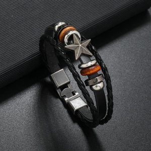 Detailed close-up of multilayer leather bracelet with star charm and metallic plug buckle