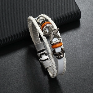 Macro view of multi-layer braided white leather bracelet with metal star and wood beads