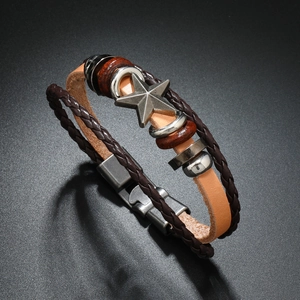 Detailed close-up of a vintage leather punk bracelet with a metal star and wooden beads