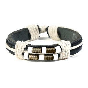 Close-up of retro multi-layer braided leather bracelet with bronze metal spring and beads