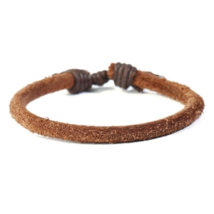 Detail of brown suede leather rope bracelet featuring handmade winding knot closure