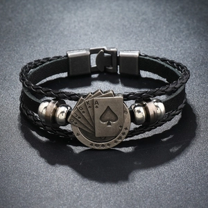 Close-up of vintage silver alloy poker card charms on a black braided leather bracelet